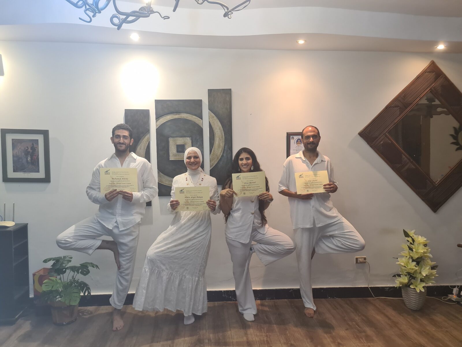 Karim Strougo with a group of yoga graduates holding their certificates